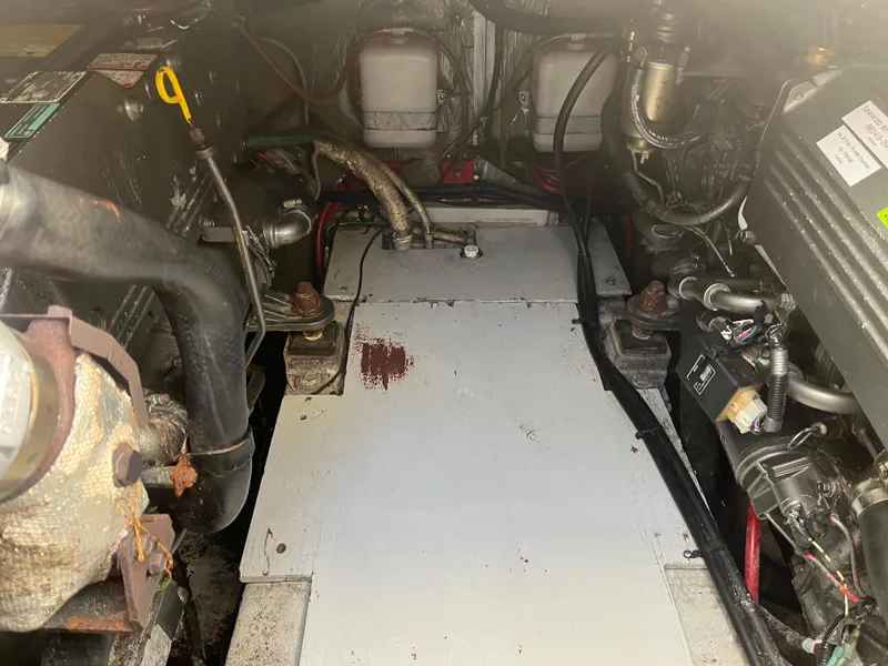 Slide: The Image of Engine compartment of a 1989 Tiara Yachts 33OPEN, showing mechanical components and wiring. - 11