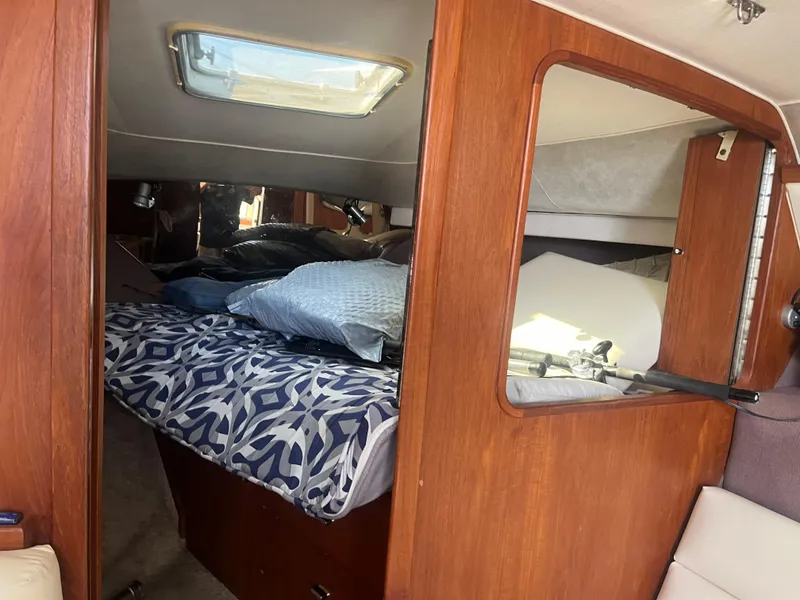 Slide: The Image of Interior cabin of 1989 Tiara Yachts 33OPEN with bed and wooden paneling. - 19