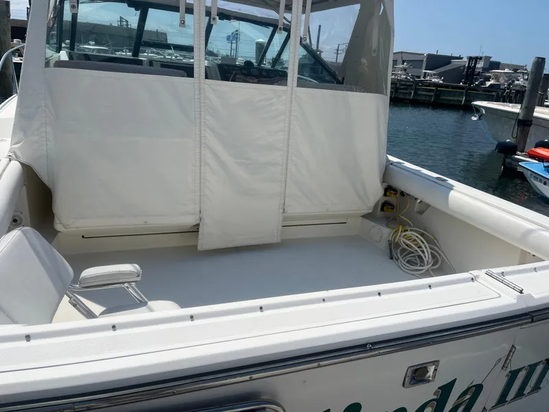 Slide: The Image of 1989 Tiara Yachts 33OPEN boat with covered cockpit, docked at marina. - 3