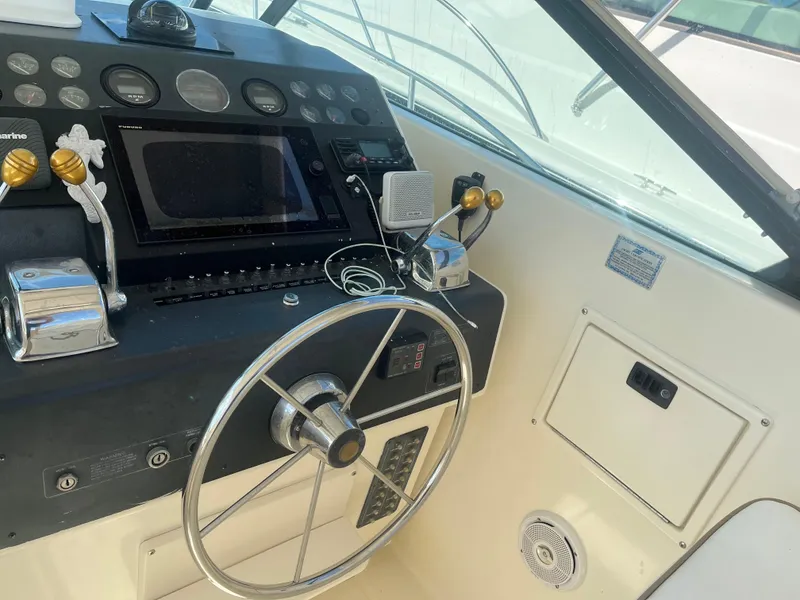 Slide: The Image of 1989 Tiara Yachts 33OPEN helm with steering wheel and control panel. - 6