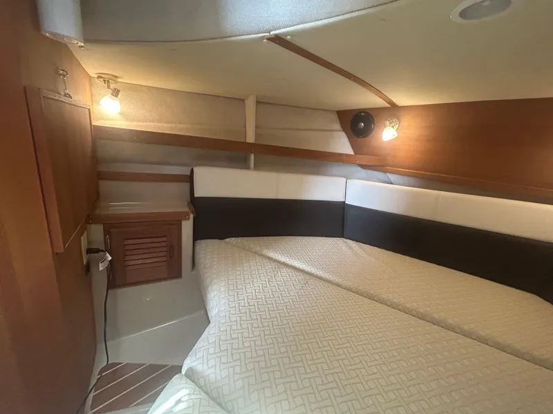 Slide: The Image of 2017 Ranger Tugs R-31 CB cabin interior with cozy lighting and comfortable bedding. - 17