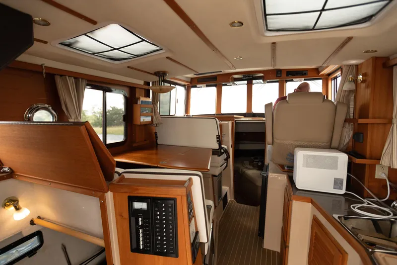 Slide: The Image of Interior of 2017 Ranger Tugs R-31 CB boat, featuring wood finishes and modern amenities. - 23