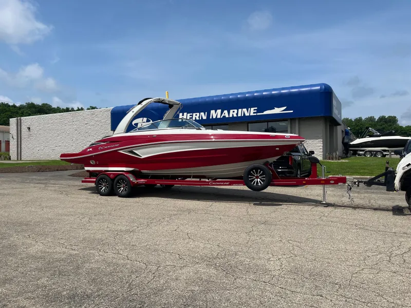 The Image of 2026 Crownline 298 SS boat on trailer outside Hern Marine dealership. - 0