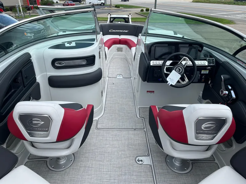 Slide: The Image of 2026 Crownline 298 SS boat interior with red and white seating, modern dashboard, and steering wheel. - 10