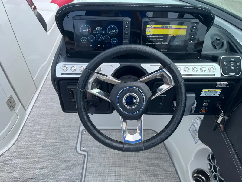 Slide: The Image of Steering wheel and dashboard of 2026 Crownline 298 SS boat with modern controls. - 19