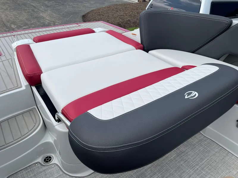 Slide: The Image of 2026 Crownline 298 SS boat with red and white cushioned seating. - 23