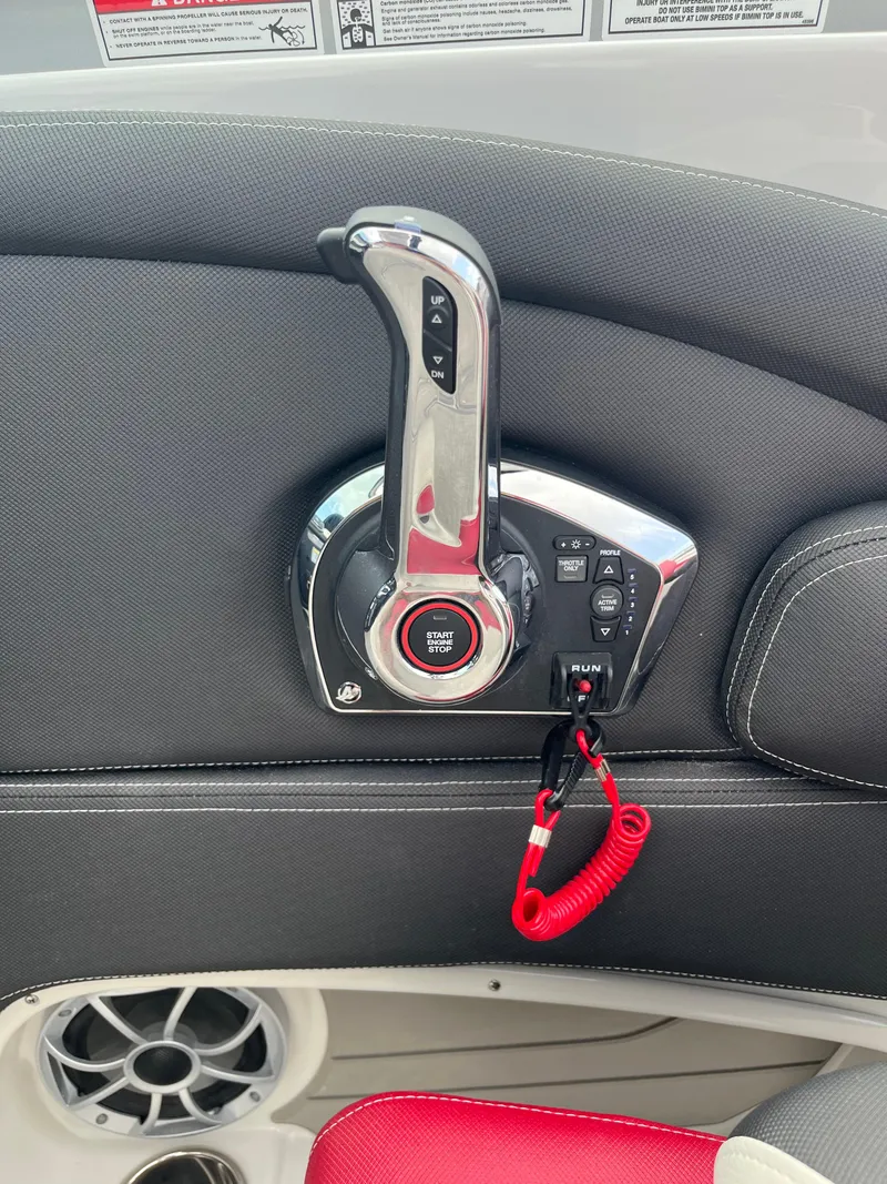 Slide: The Image of Throttle control panel of 2026 Crownline 298 SS boat with start/stop button and safety lanyard. - 26