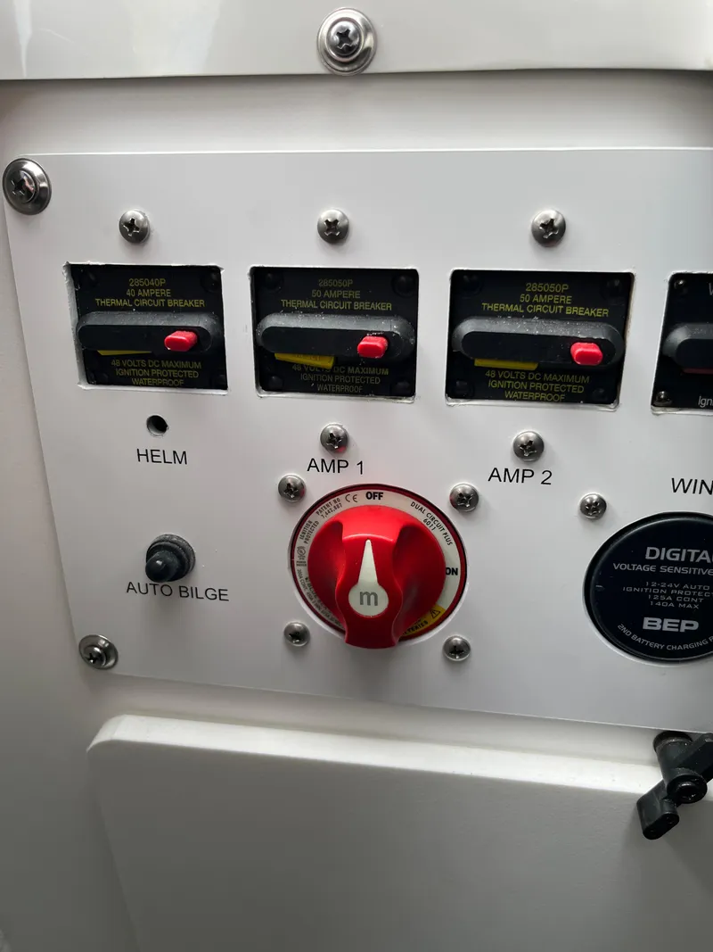 Slide: The Image of Control panel of 2026 Crownline 298 SS boat with circuit breakers and switches. - 4