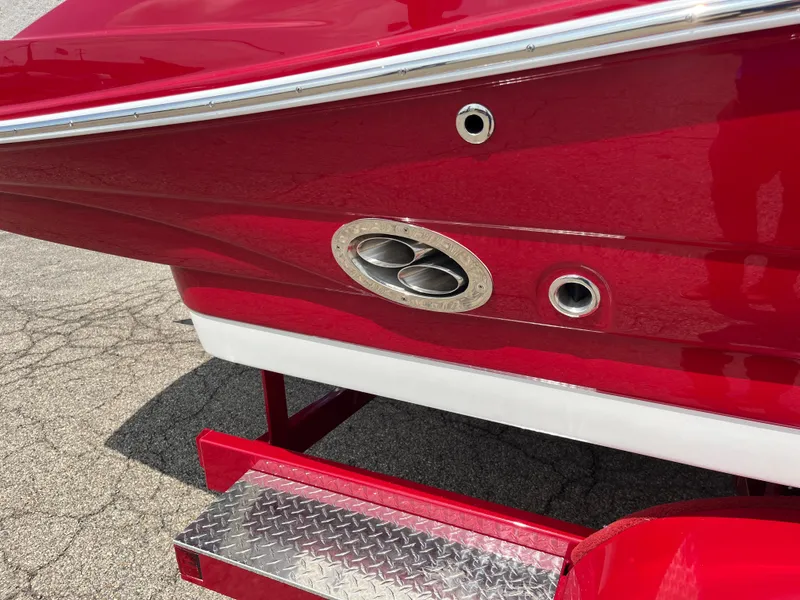 Slide: The Image of Red 2026 Crownline 298 SS boat with chrome exhaust detail and diamond plate step. - 7