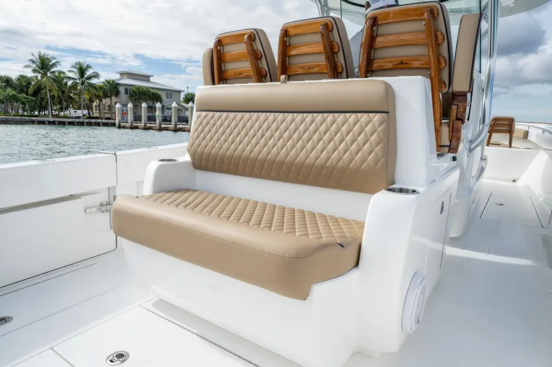Slide: The Image of 2026 Valhalla Boatworks V-33 interior with luxurious tan seating and ocean backdrop. - 7