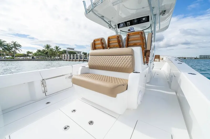 Slide: The Image of 2026 Valhalla Boatworks V-33 with luxurious seating, docked by palm trees and waterfront. - 9