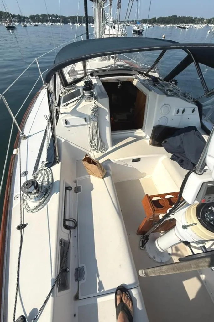 Slide: The Image of Cockpit view of a 1986 Pearson 33-2 sailboat on calm waters. - 12
