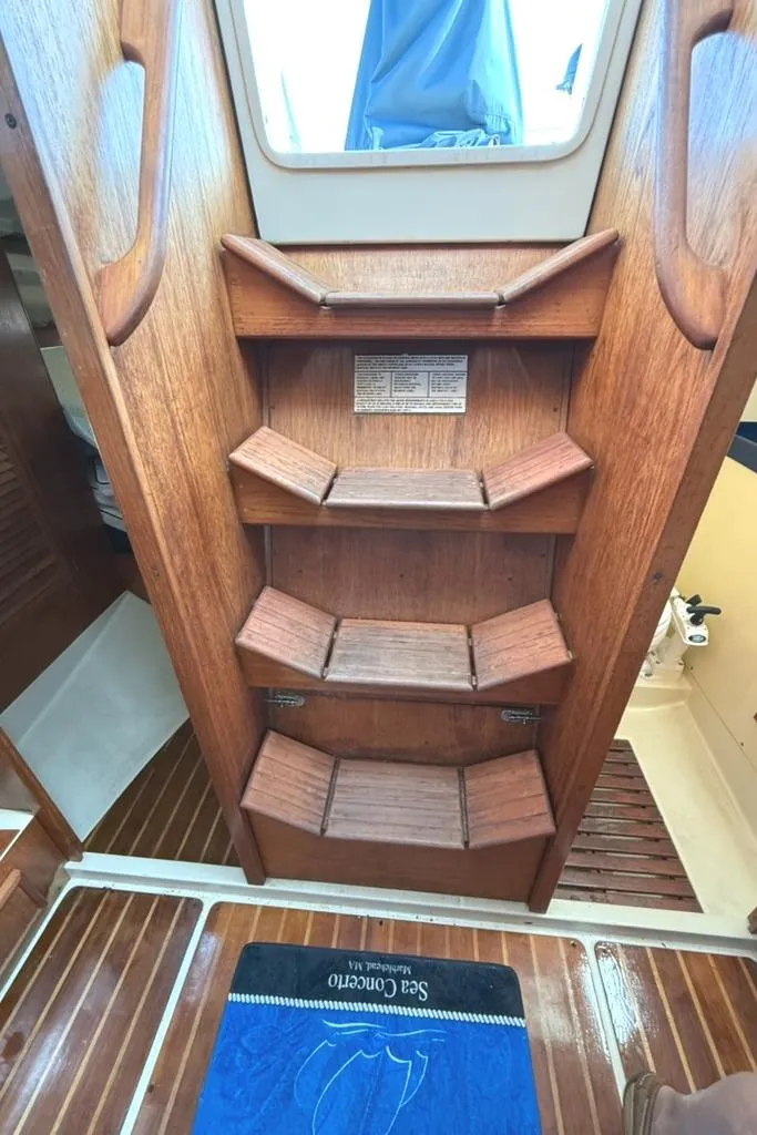 Slide: The Image of Wooden interior stairs of a 1986 Pearson 33-2 sailboat cabin. - 21