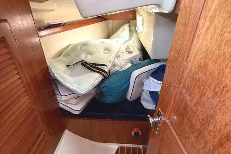 Slide: The Image of Interior cabin of 1986 Pearson 33-2 sailboat with mattresses and storage items. - 22