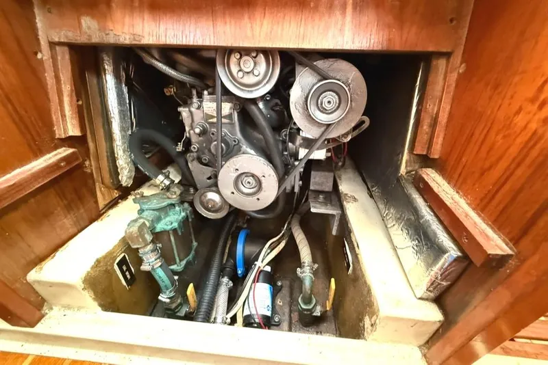 Slide: The Image of Engine compartment of a 1986 Pearson 33-2 sailboat, showcasing mechanical components. - 27