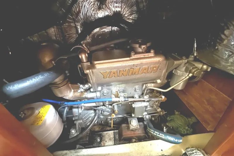 Slide: The Image of Yanmar engine inside a 1986 Pearson 33-2 sailboat, showcasing mechanical components. - 29