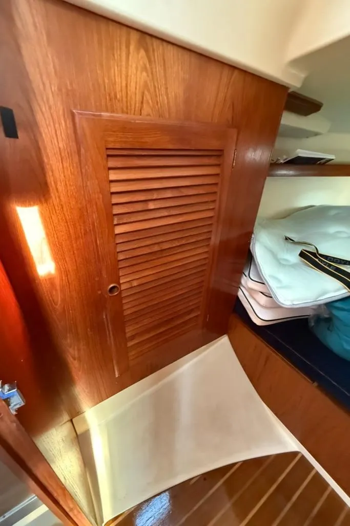 Slide: The Image of Wooden interior of 1986 Pearson 33-2 sailboat with storage and cushions. - 31