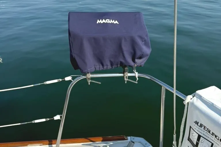 Slide: The Image of Sailboat grill with cover on Pearson 33-2, 1986 model, over calm water. - 8