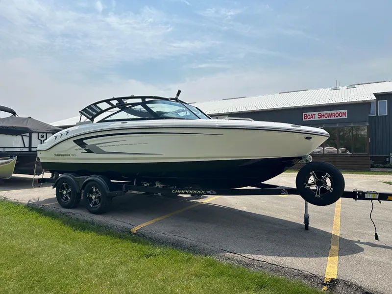 Slide: The Image of 2025 Chaparral 21 SSi boat on trailer outside showroom. - 5