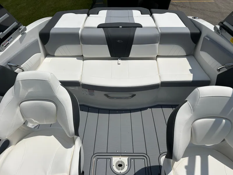 Slide: The Image of 2025 Chaparral 21 SSi boat interior with white and gray seating, modern design. - 6