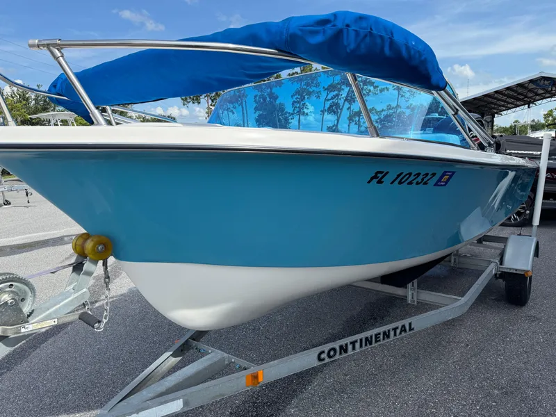 Slide: The Image of 1963 T Craft VHULL boat with blue cover on a Continental trailer. - 3
