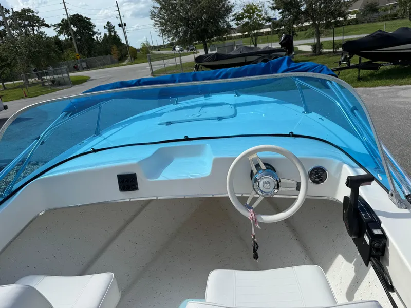 Slide: The Image of 1963 T Craft VHULL boat interior with blue windshield and white steering wheel. - 6