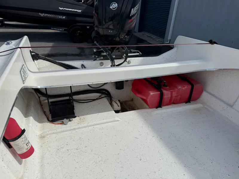 Slide: The Image of 1963 T Craft VHULL boat interior with motor, fuel tank, and fire extinguisher. - 9