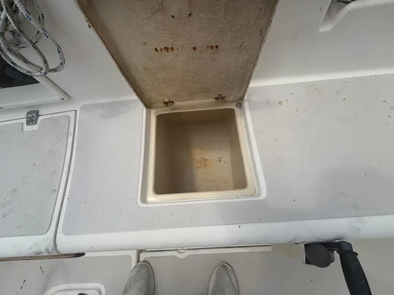 Slide: The Image of Open storage compartment on 1986 Island Packet IP27 Cutter sailboat deck. - 10