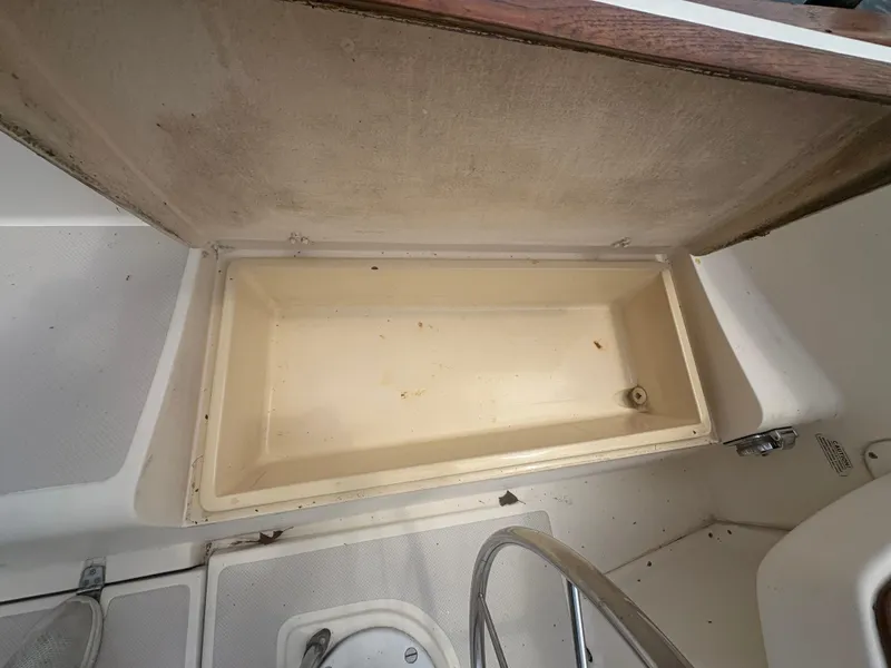 Slide: The Image of Open storage compartment on 1986 Island Packet IP27 Cutter sailboat. - 11