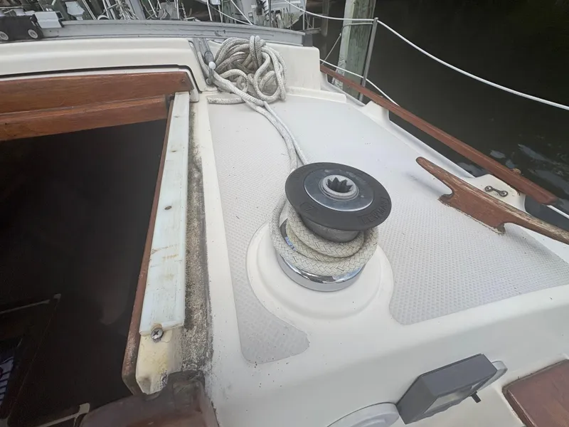 Slide: The Image of 1986 Island Packet IP27 Cutter deck with winch and coiled rope. - 14