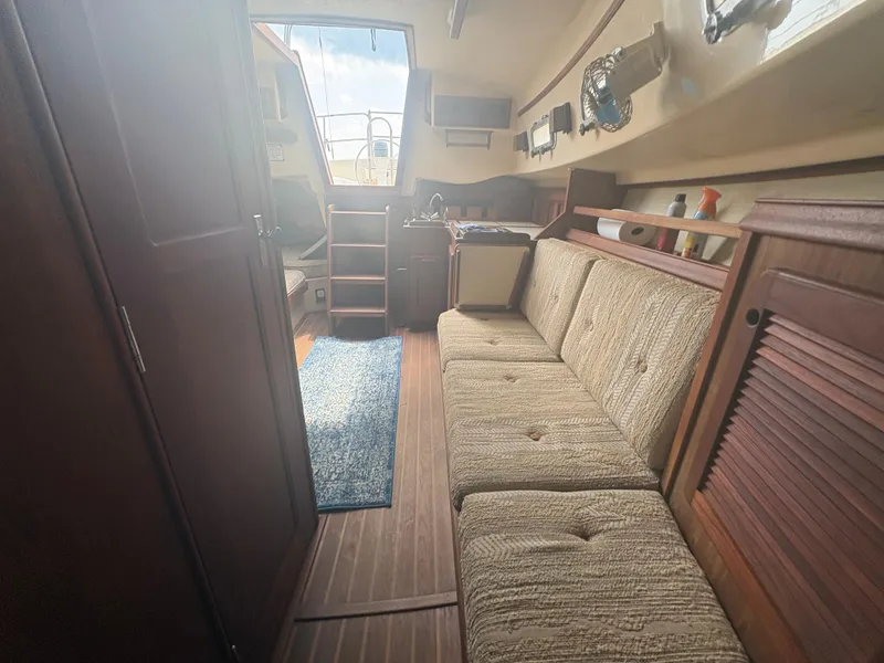 Slide: The Image of Interior of 1986 Island Packet IP27 Cutter with cozy seating and wooden finishes. - 18