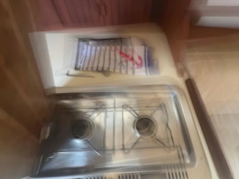 Slide: The Image of Blurry view of a stove in a 1986 Island Packet IP27 Cutter sailboat kitchen. - 23