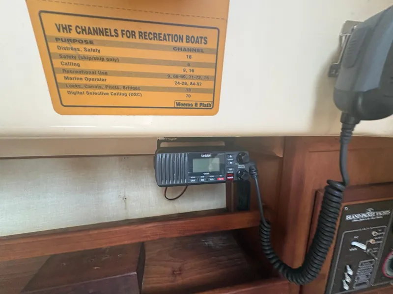 Slide: The Image of VHF radio and channel guide on 1986 Island Packet IP27 Cutter sailboat. - 27