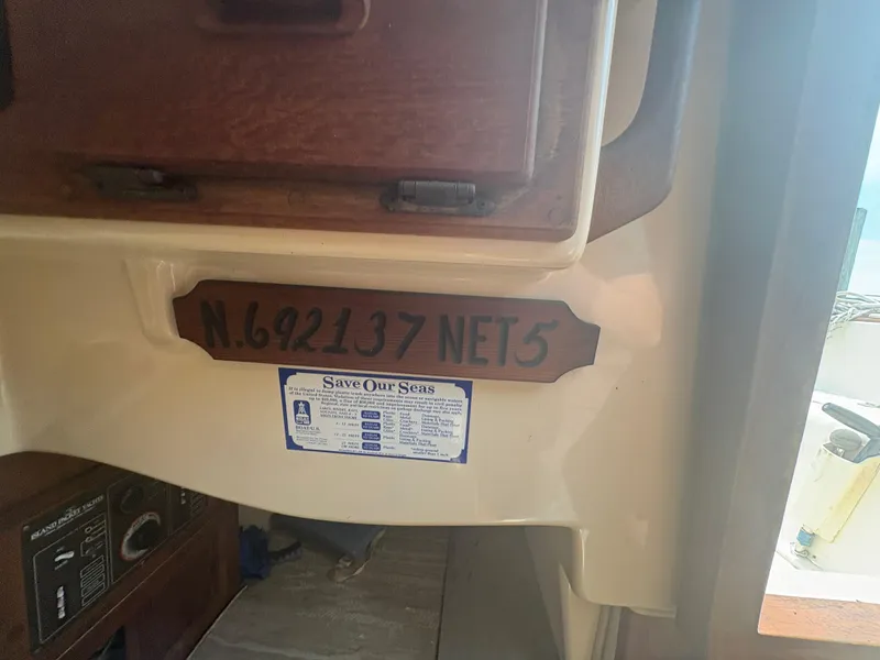 Slide: The Image of Interior of 1986 Island Packet IP27 Cutter with registration number and "Save Our Seas" sticker. - 29