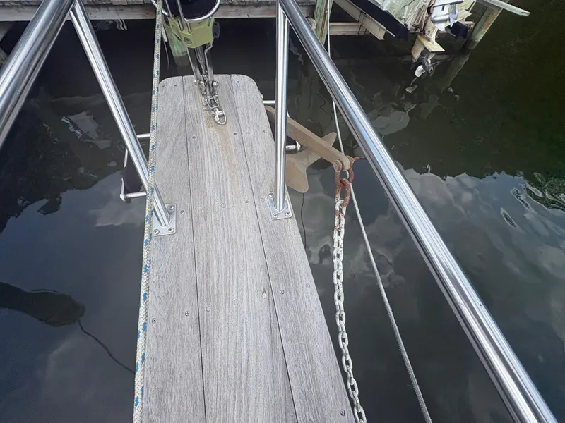 Slide: The Image of Bow of 1986 Island Packet IP27 Cutter with anchor and chain at dock. - 4