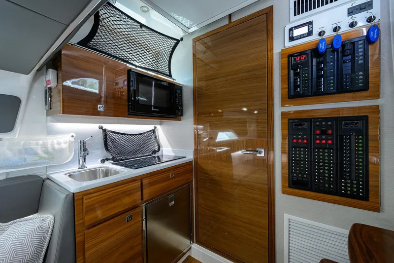 Slide: The Image of 2026 Valhalla Boatworks V-46 interior with modern kitchen and control panels. - 13