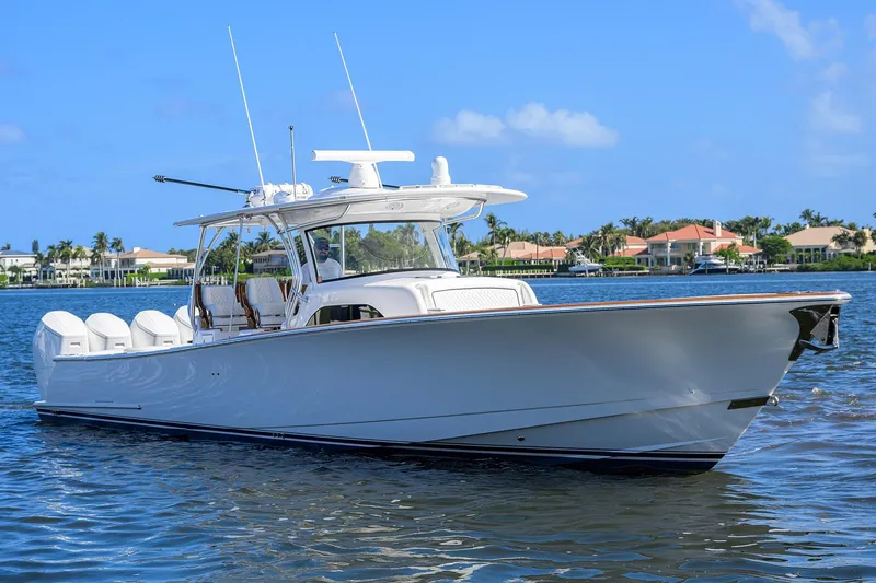 Slide: The Image of 2026 Valhalla Boatworks V-46 cruising on a sunny day, showcasing sleek design and powerful engines. - 2