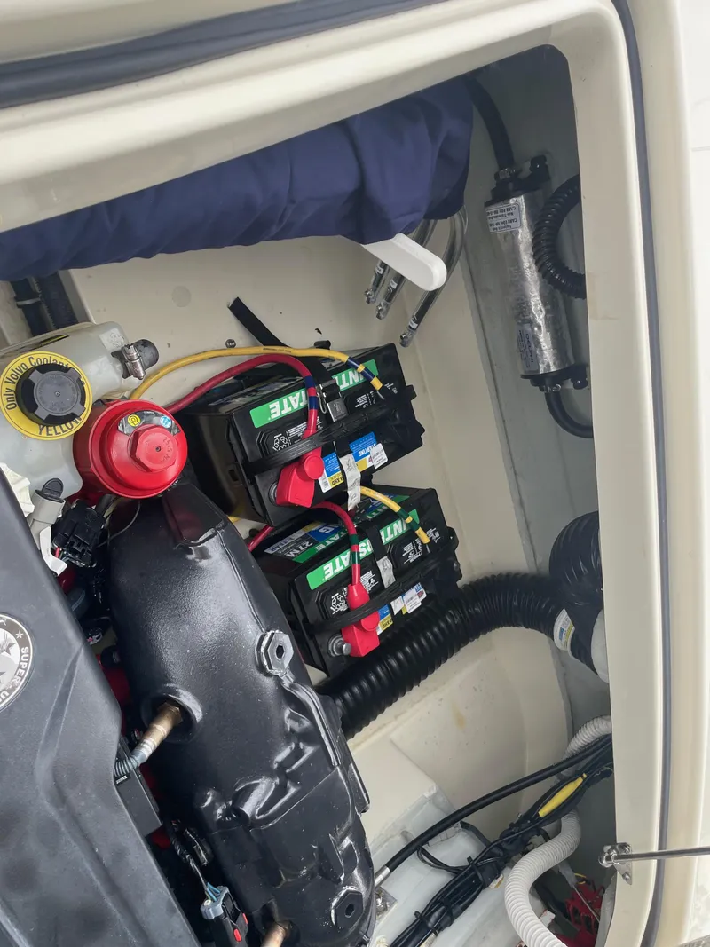 Slide: The Image of 2020 Chris-Craft Launch 23 engine compartment with batteries and wiring visible. - 10