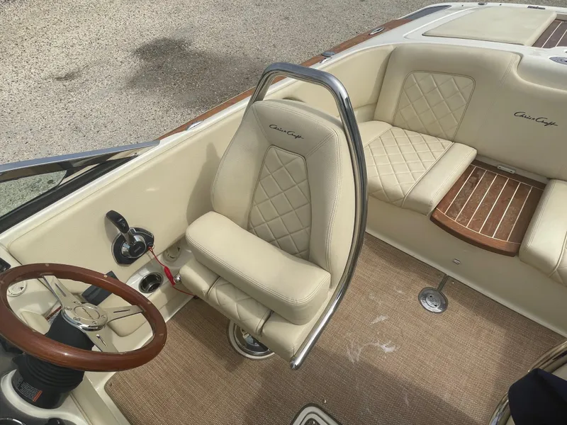 Slide: The Image of 2020 Chris-Craft Launch 23 interior with beige leather seats and wooden steering wheel. - 13