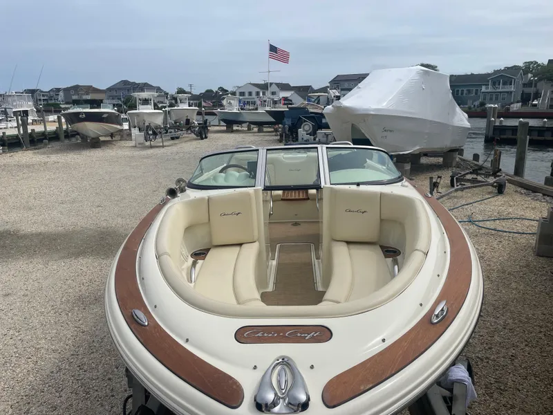 Slide: The Image of 2020 Chris-Craft Launch 23 boat docked, featuring elegant design and luxurious seating. - 24