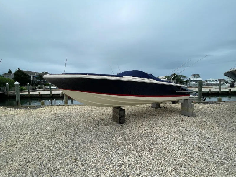 Slide: The Image of 2020 Chris-Craft Launch 23 boat on dry dock, side view, overcast sky. - 30