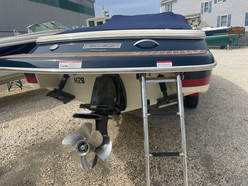 Slide: The Image of 2020 Chris-Craft Launch 23 boat rear view with propeller and ladder. - 4