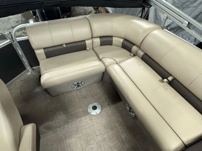 Slide: The Image of 2023 Sun Tracker Party Barge 20 DLX interior with beige seating and speaker system. - 11