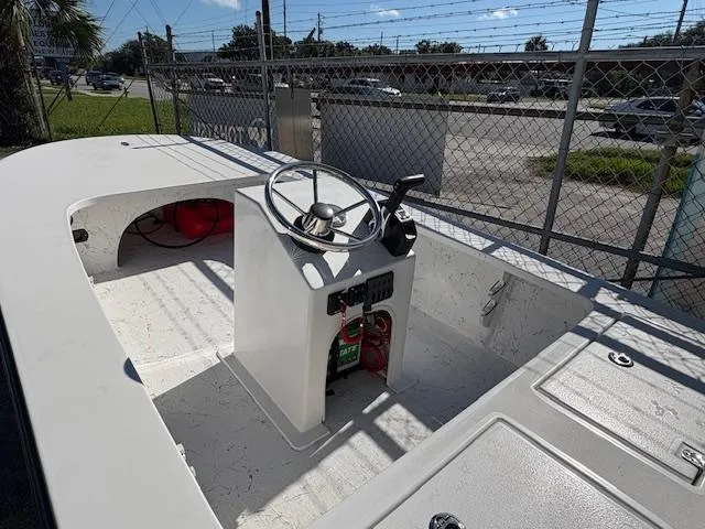 Slide: The Image of 2025 Mitzi Skiff 15 boat interior with steering console and storage compartments. - 4