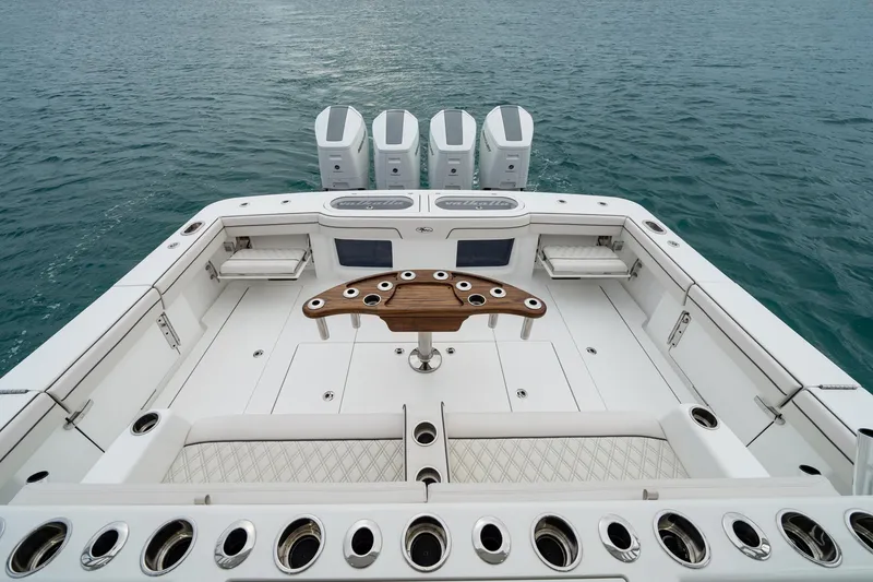 Slide: The Image of Valhalla Boatworks V-55, 2026 model, featuring spacious deck and quad engines on open water. - 15