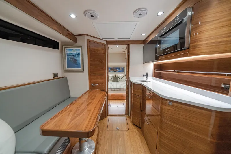 Slide: The Image of Luxurious interior of 2026 Valhalla Boatworks V-55 with modern kitchen and seating area. - 8
