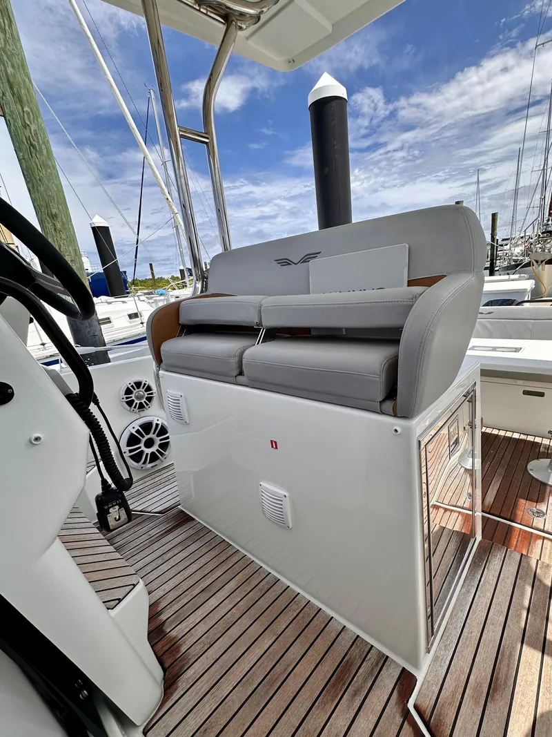 Slide: The Image of 2023 Beneteau Flyer 9 SUNdeck interior with cushioned seating and wooden flooring. - 10