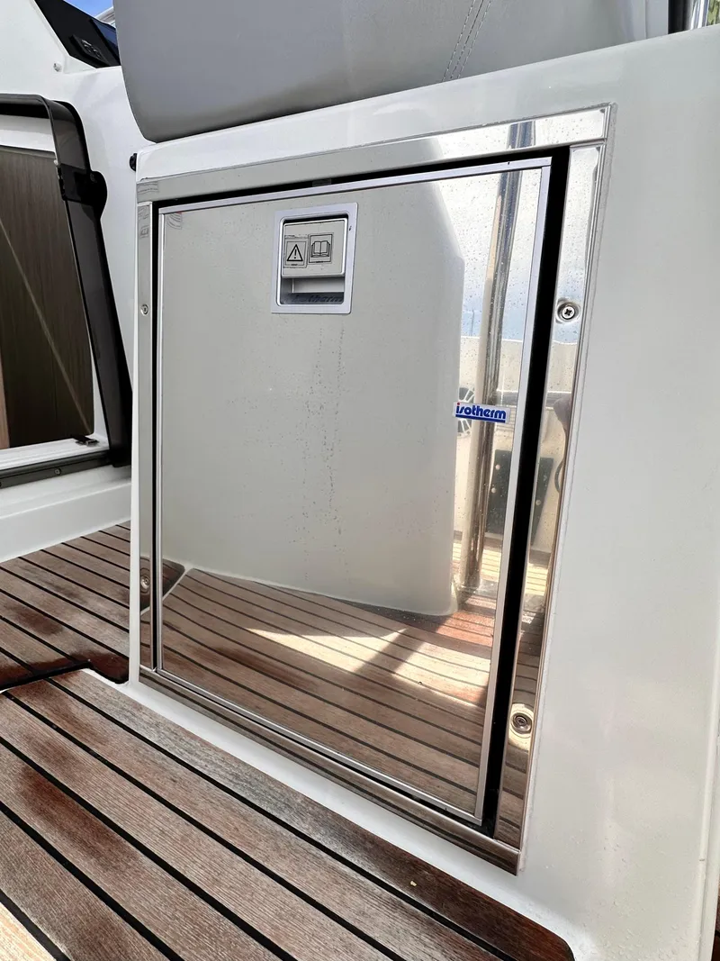 Slide: The Image of 2023 Beneteau Flyer 9 SUNdeck interior with sleek stainless steel door and wooden flooring. - 11