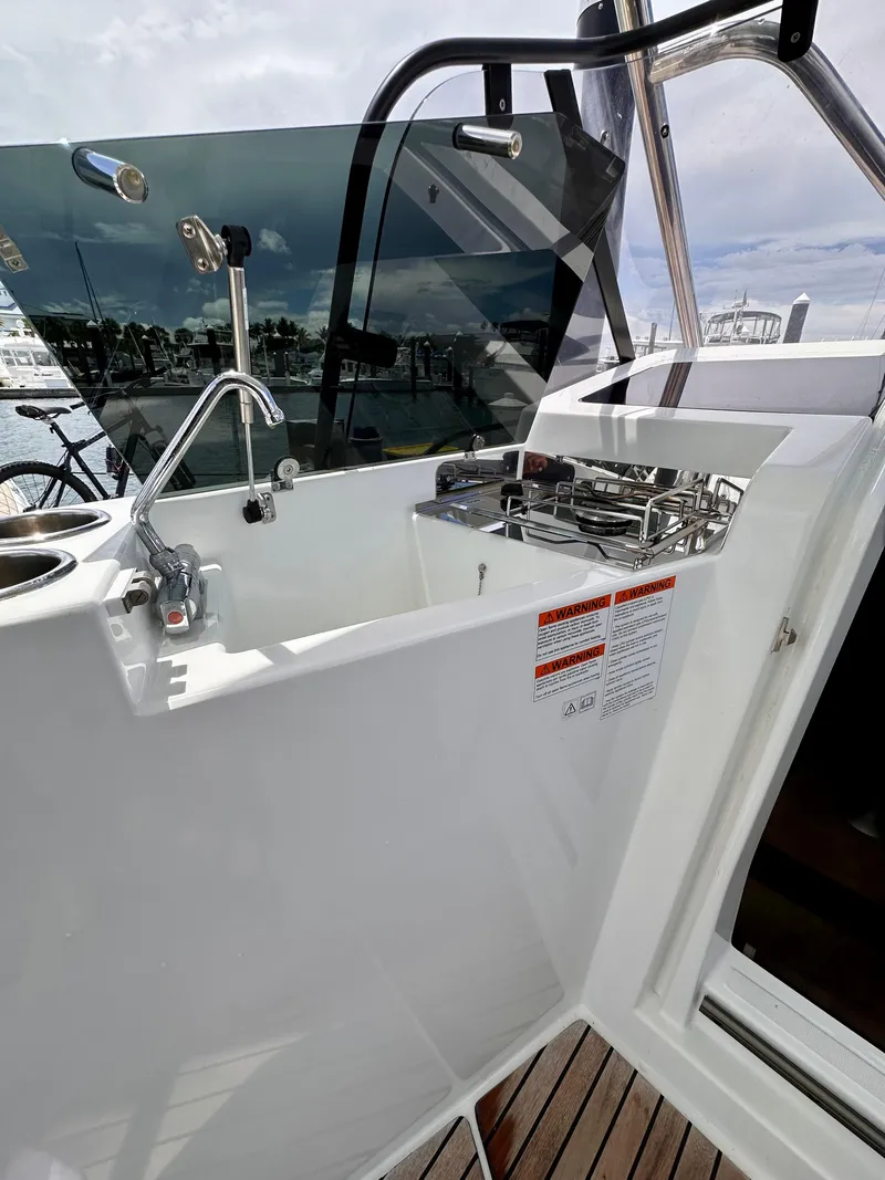 Slide: The Image of 2023 Beneteau Flyer 9 SUNdeck boat kitchen area with sink and stove. - 12