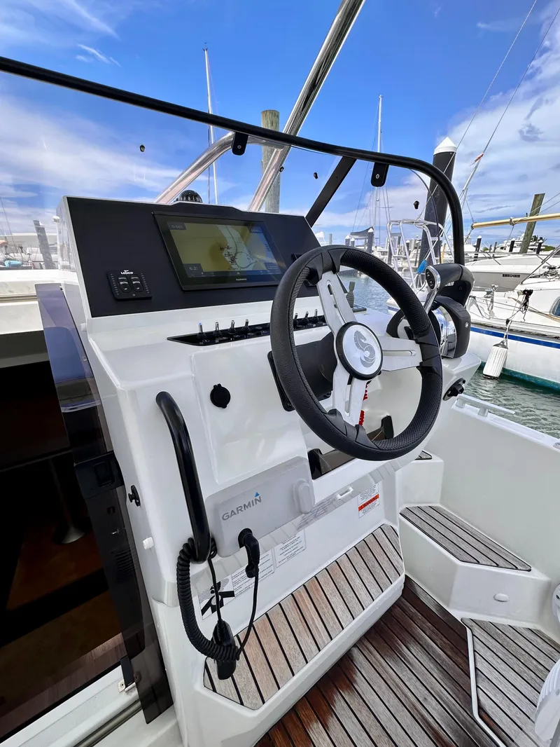 Slide: The Image of 2023 Beneteau Flyer 9 SUNdeck helm with Garmin navigation system, docked at marina. - 13